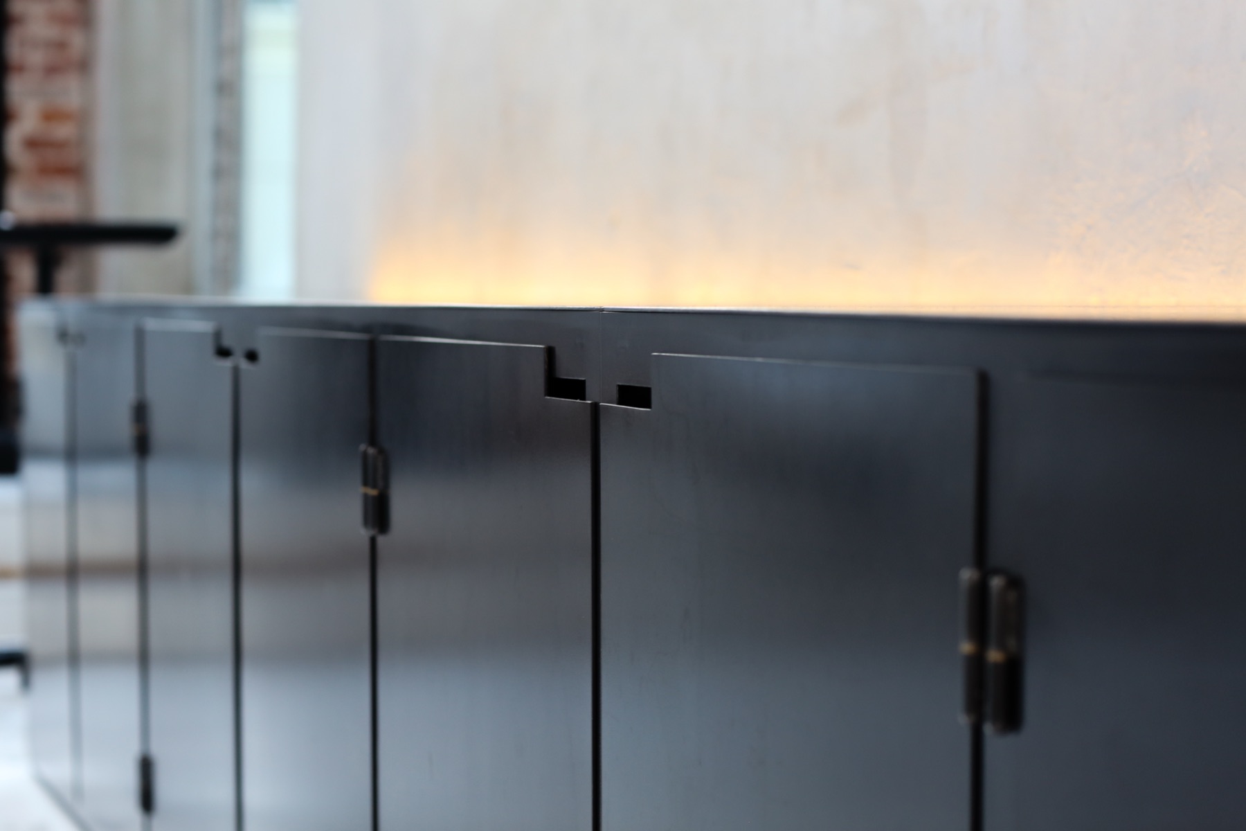 Black cabinetry with notched pulls