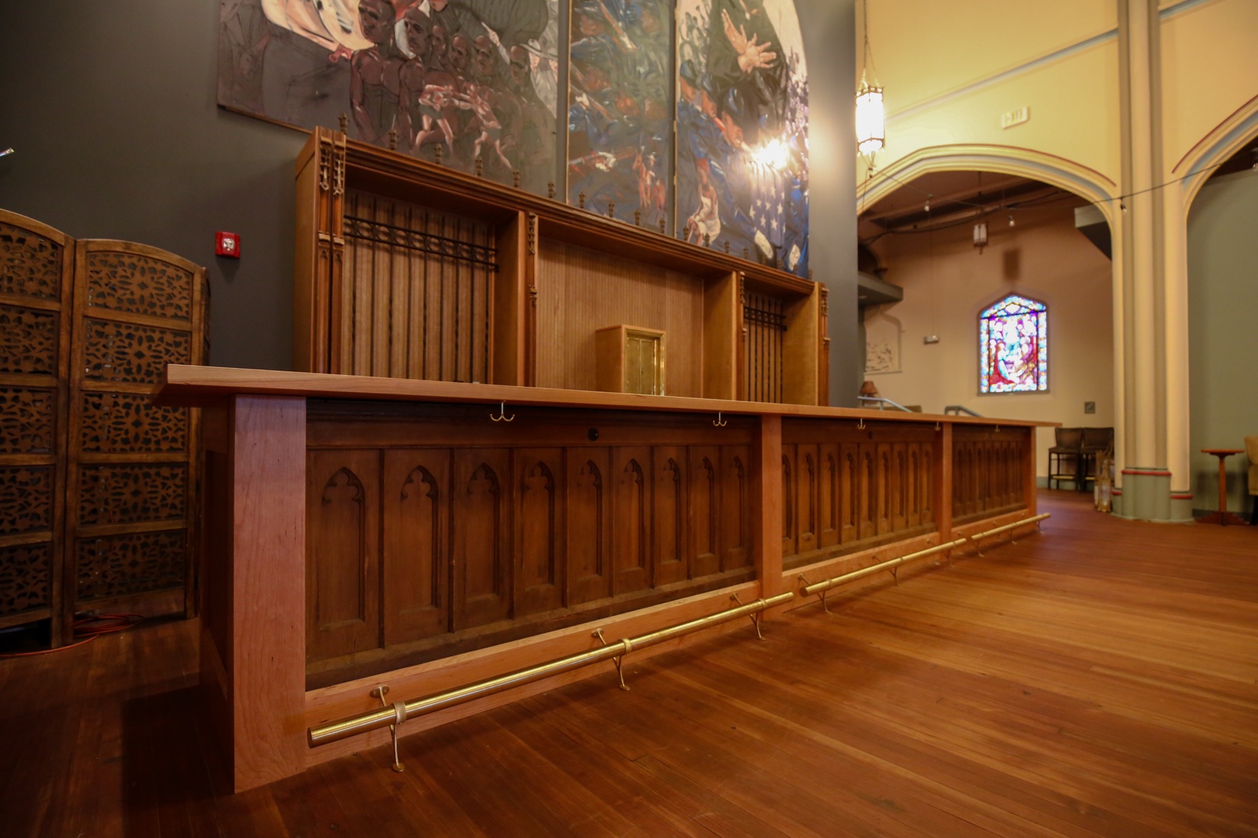 Long wooden bar with gothic paneling inside a former church