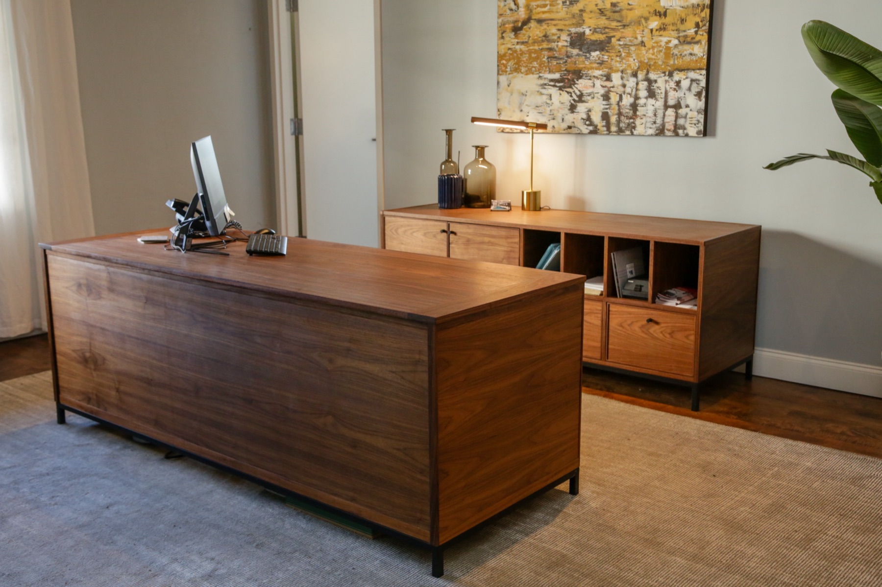 Walnut executive desk and credenza on blackened steel bases