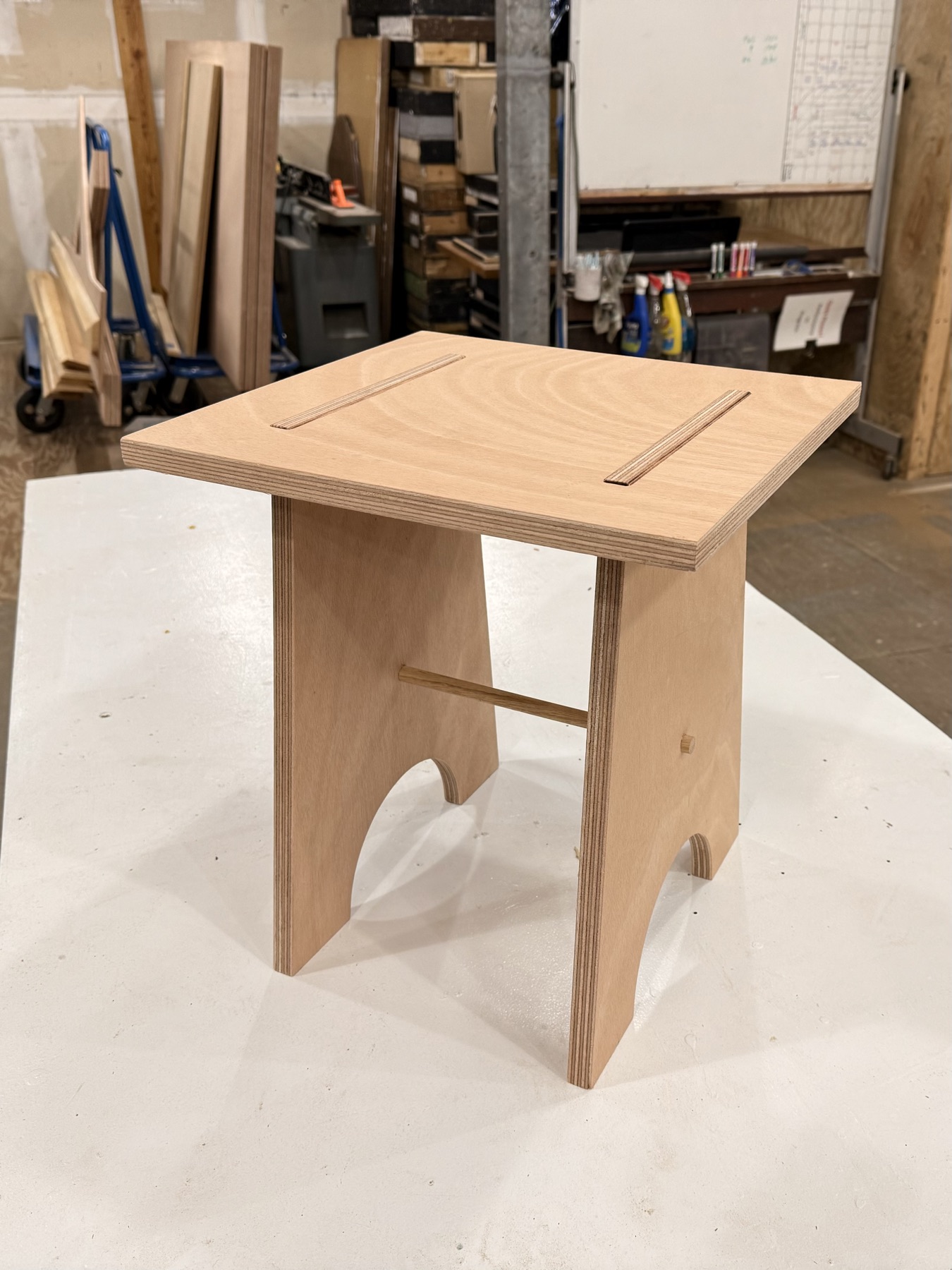 Plywood stool with arched legs in the Tulane shop