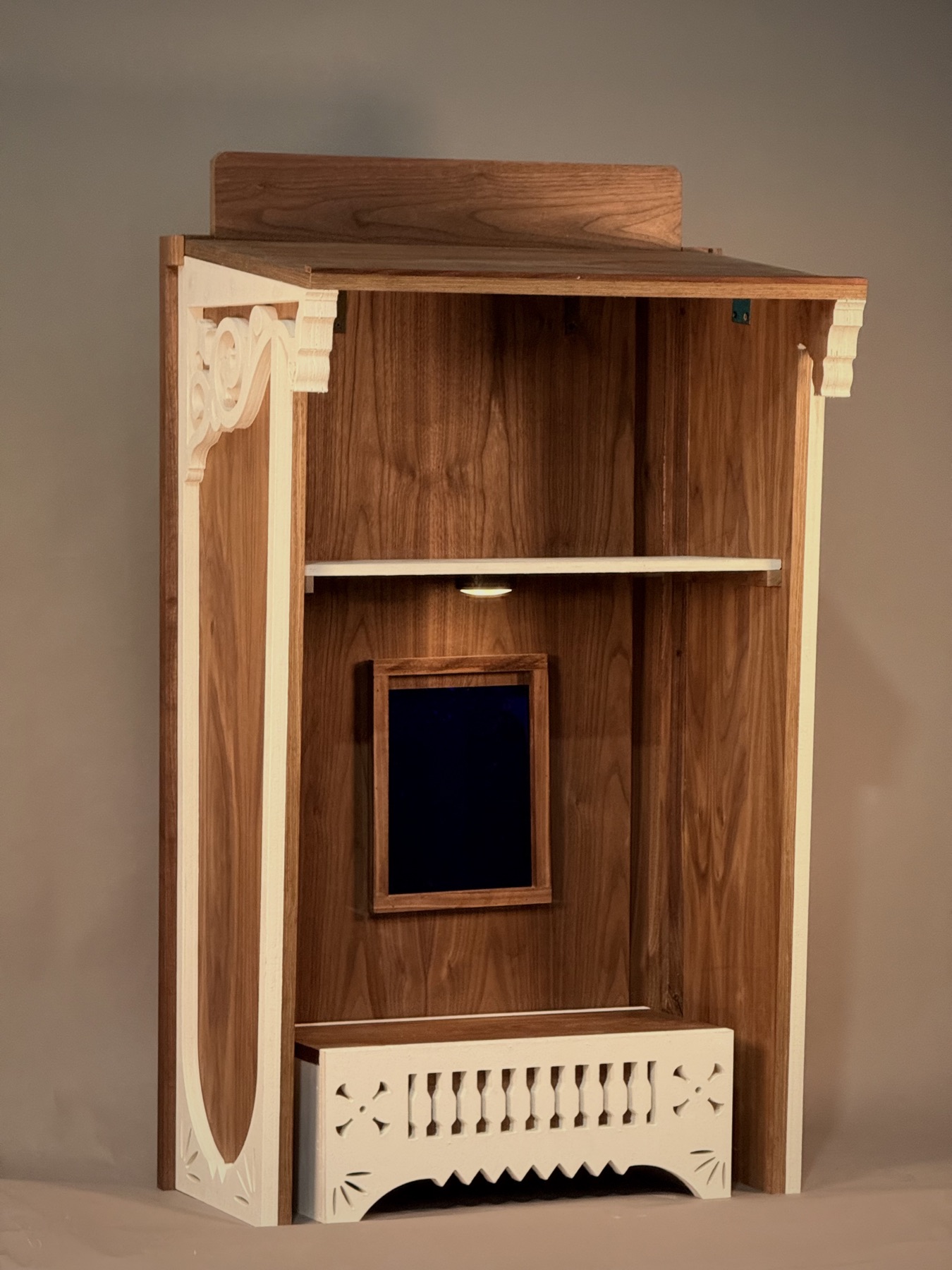 Lectern interior with walnut shelf and white fretwork