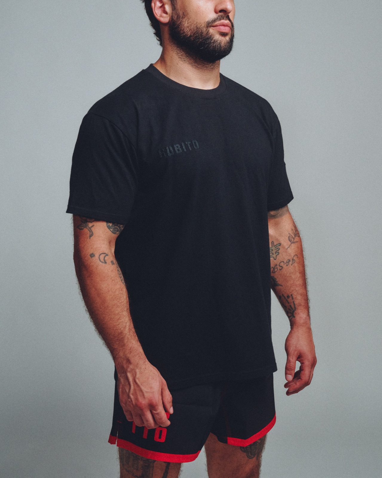 Athlete in black Subito tee and shorts, studio shot