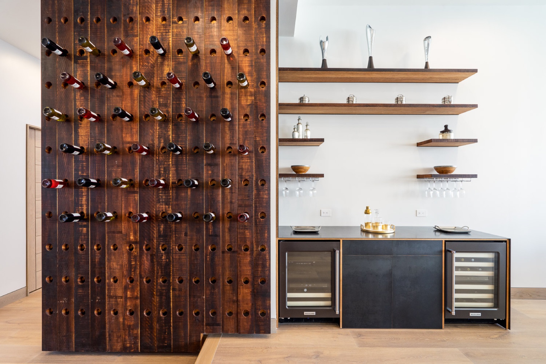 Reclaimed wood wine wall with floating walnut shelves
