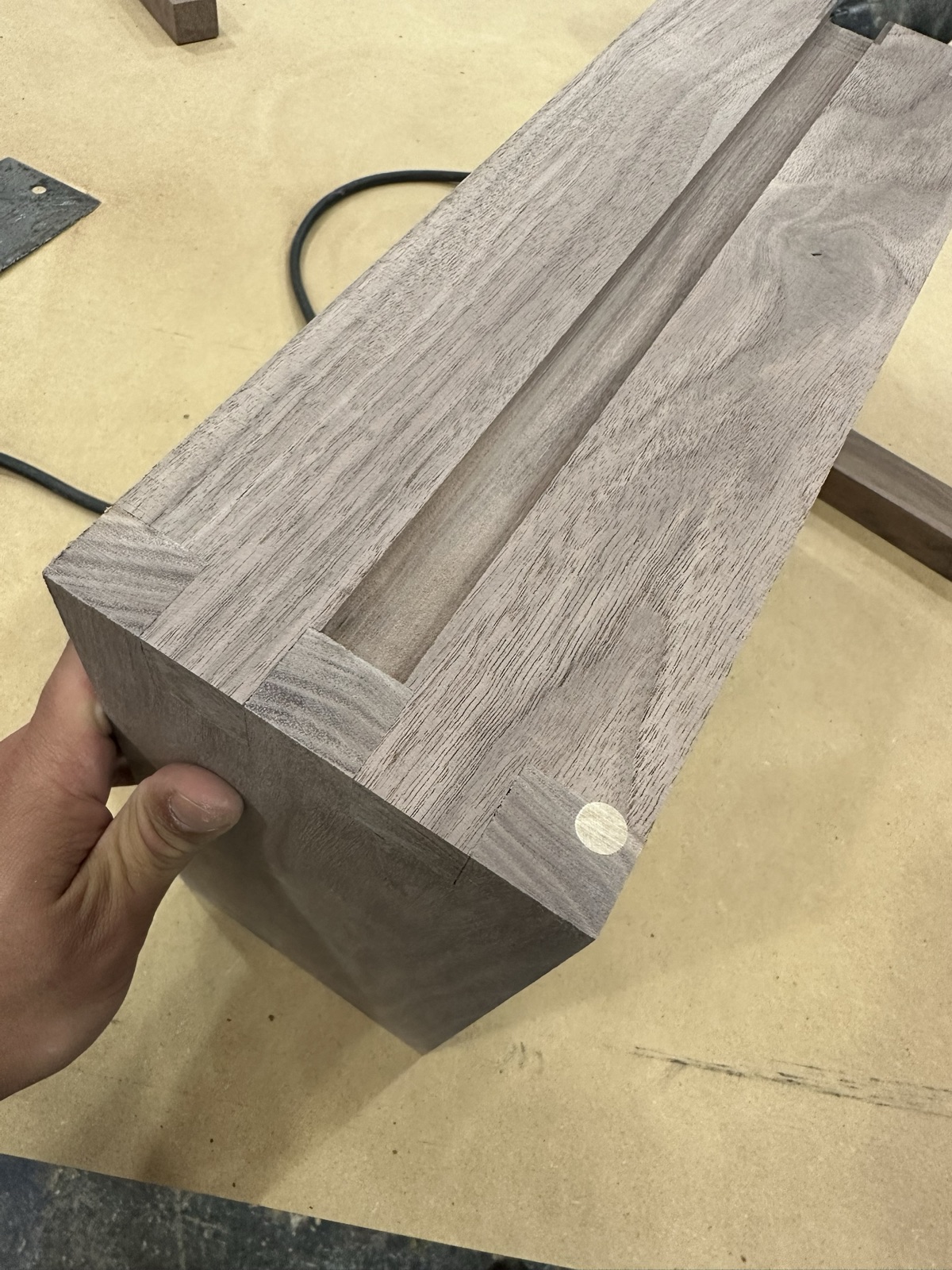 Walnut case corner with an inlaid pin, mid build