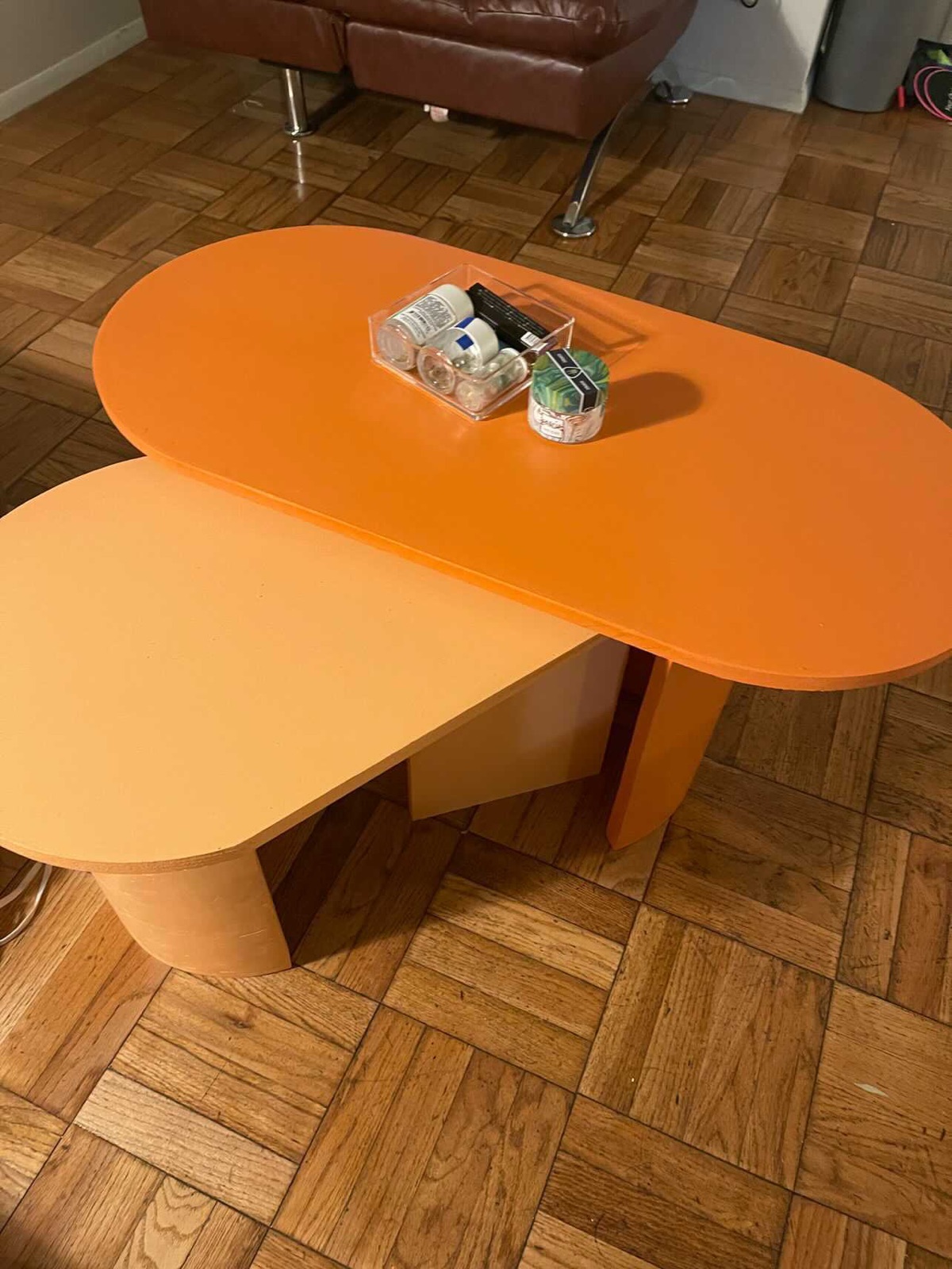 Two orange pill-shaped nesting tables