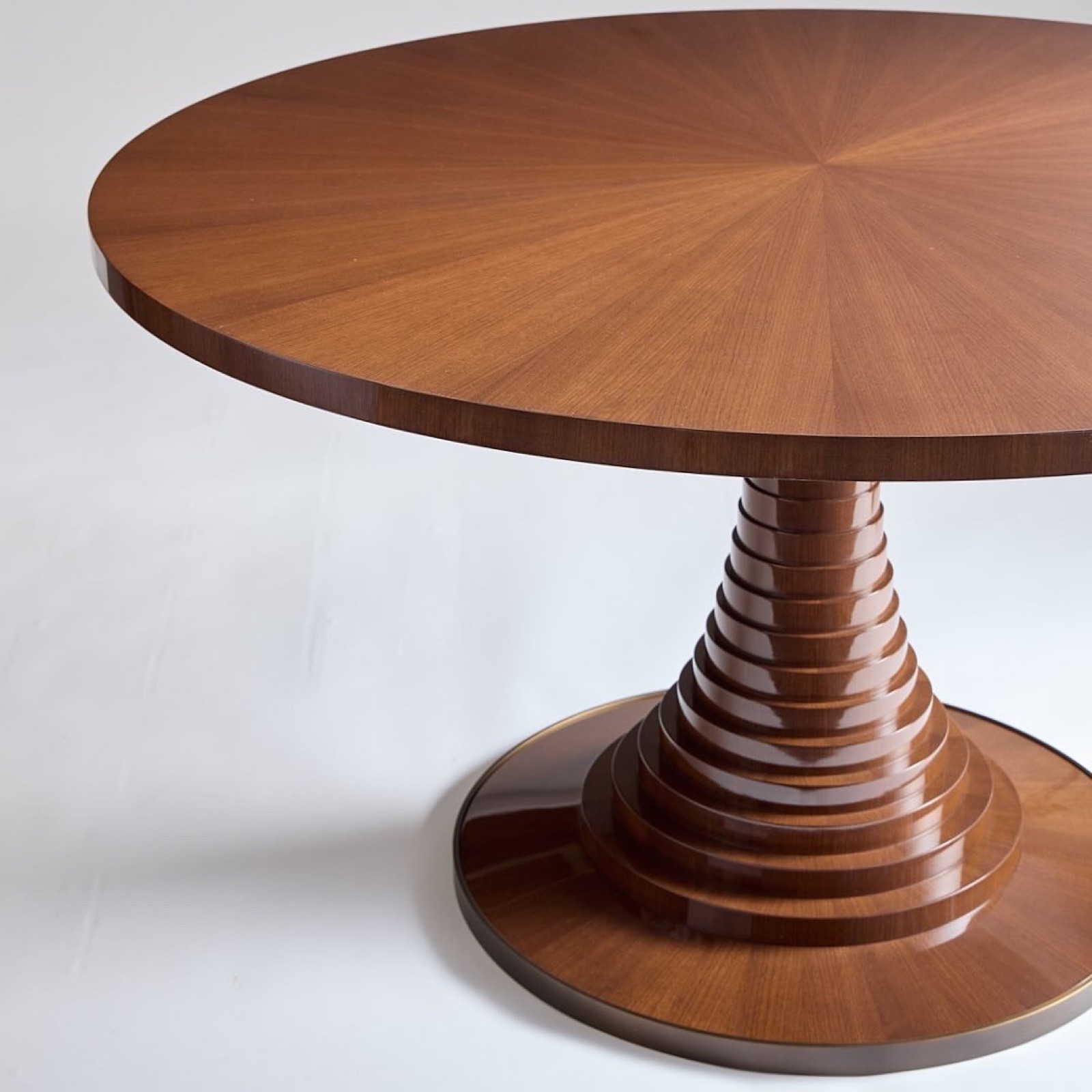 Pedestal table with a sunburst veneer top