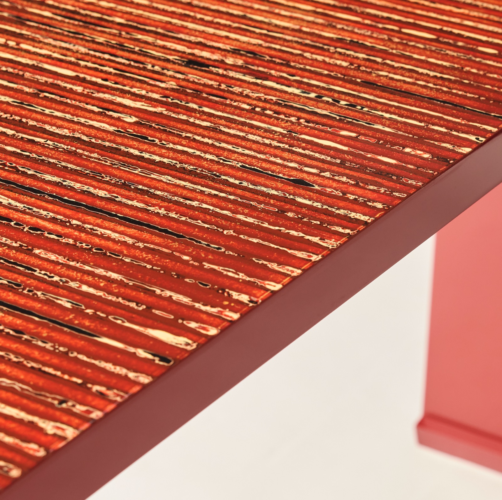 Corner of the striped lacquer top over a coral base
