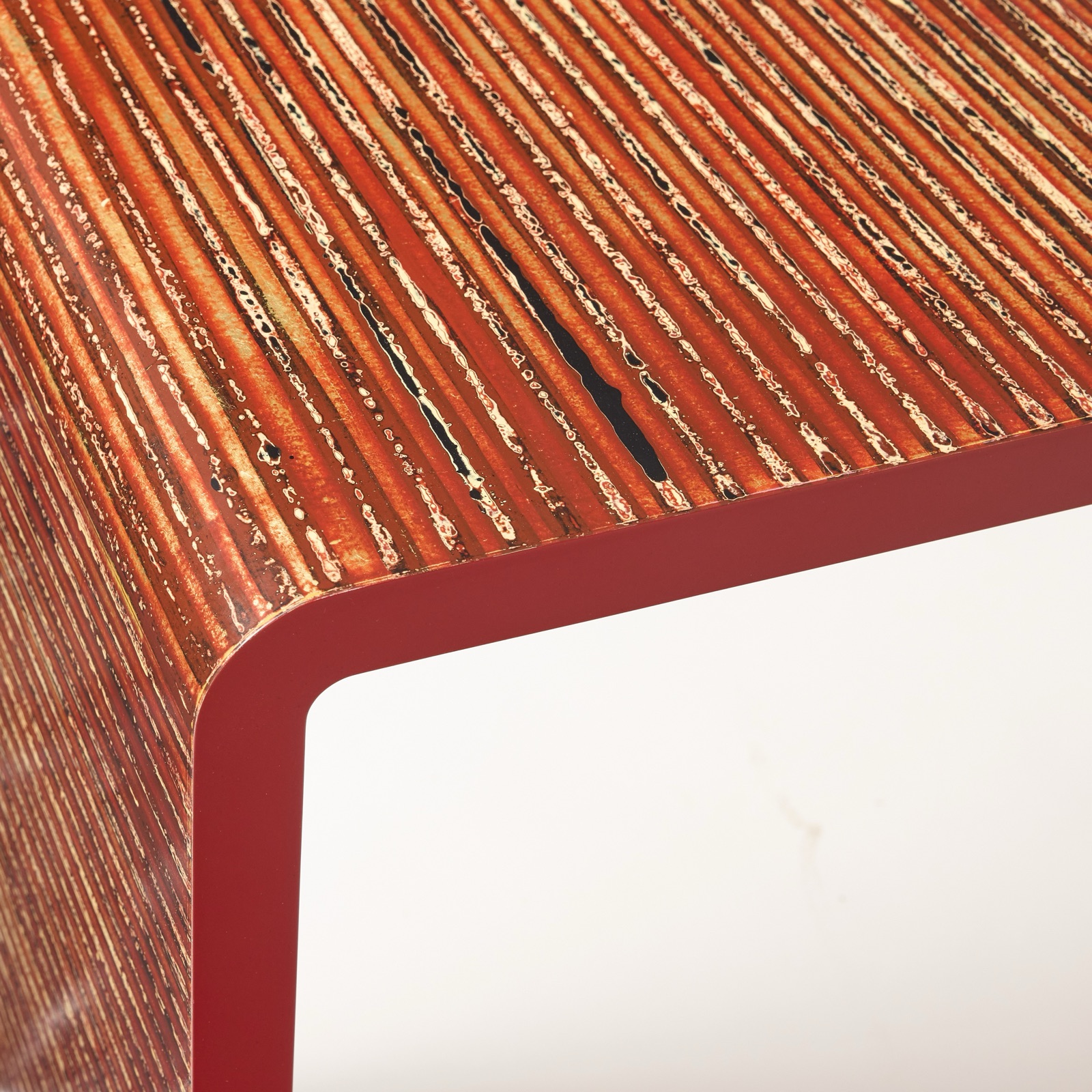 Lacquered waterfall table with a striped, gilded top