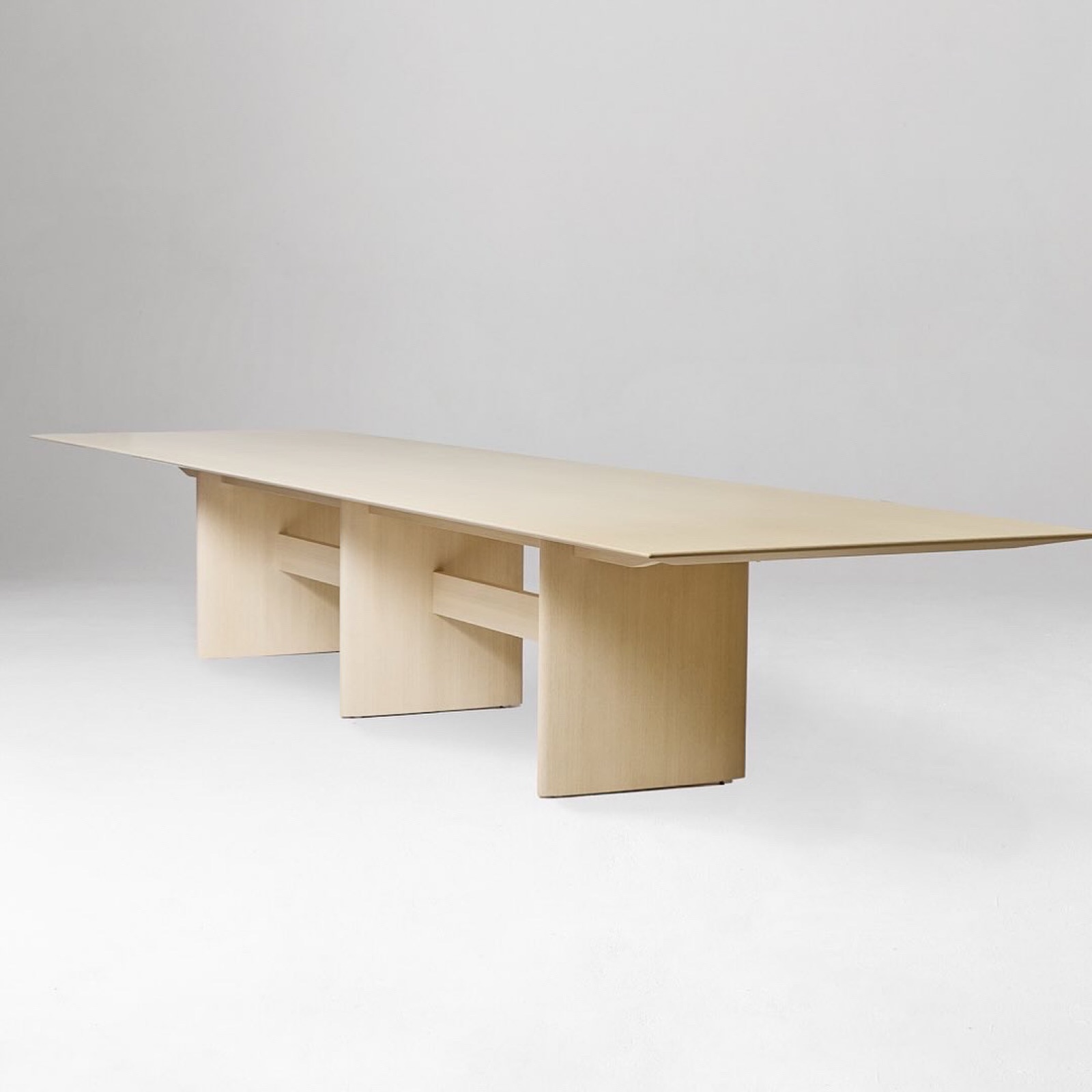 Long conference table with three panel legs and stretchers