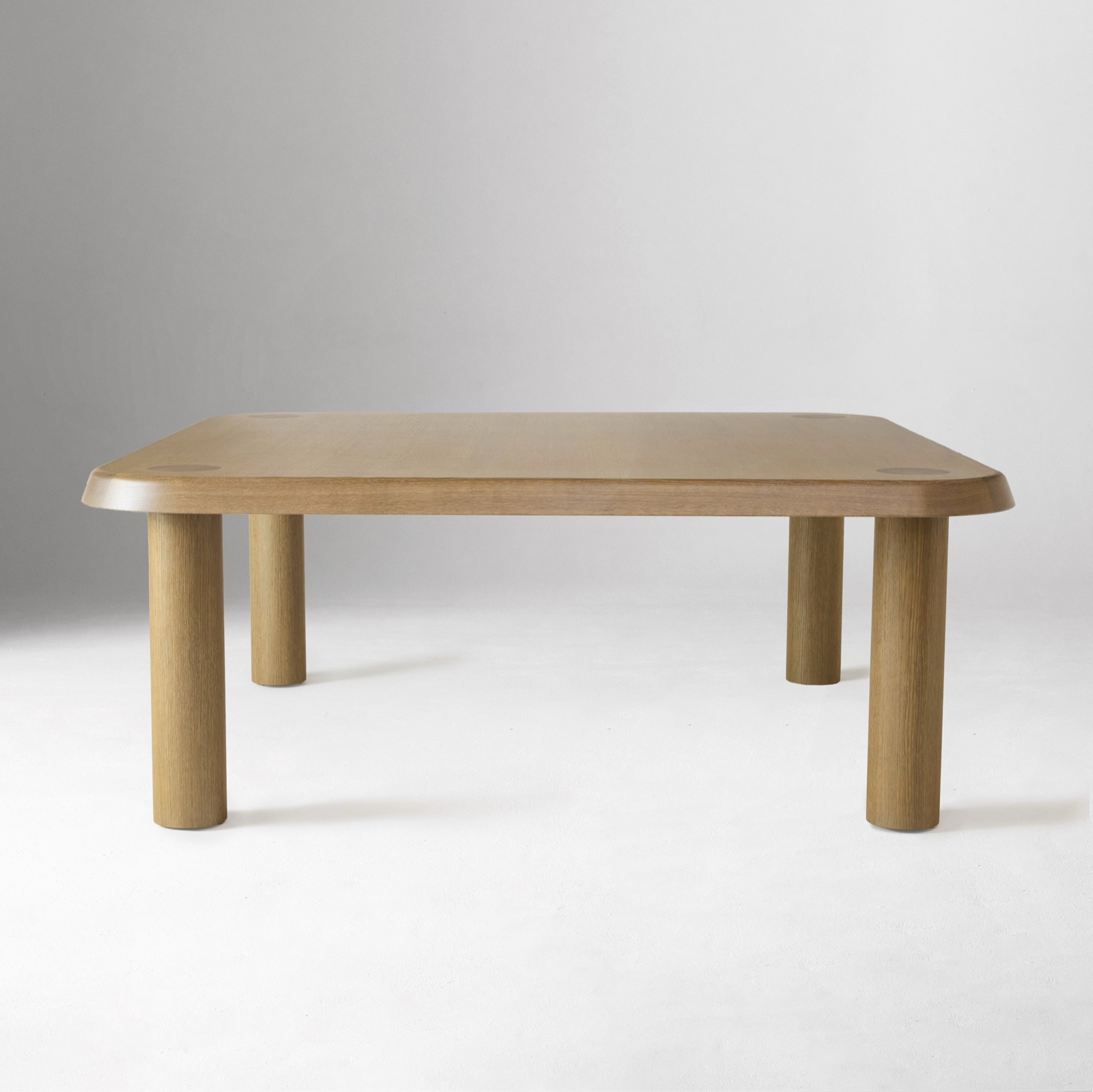 Low square table with rounded corners and four round legs