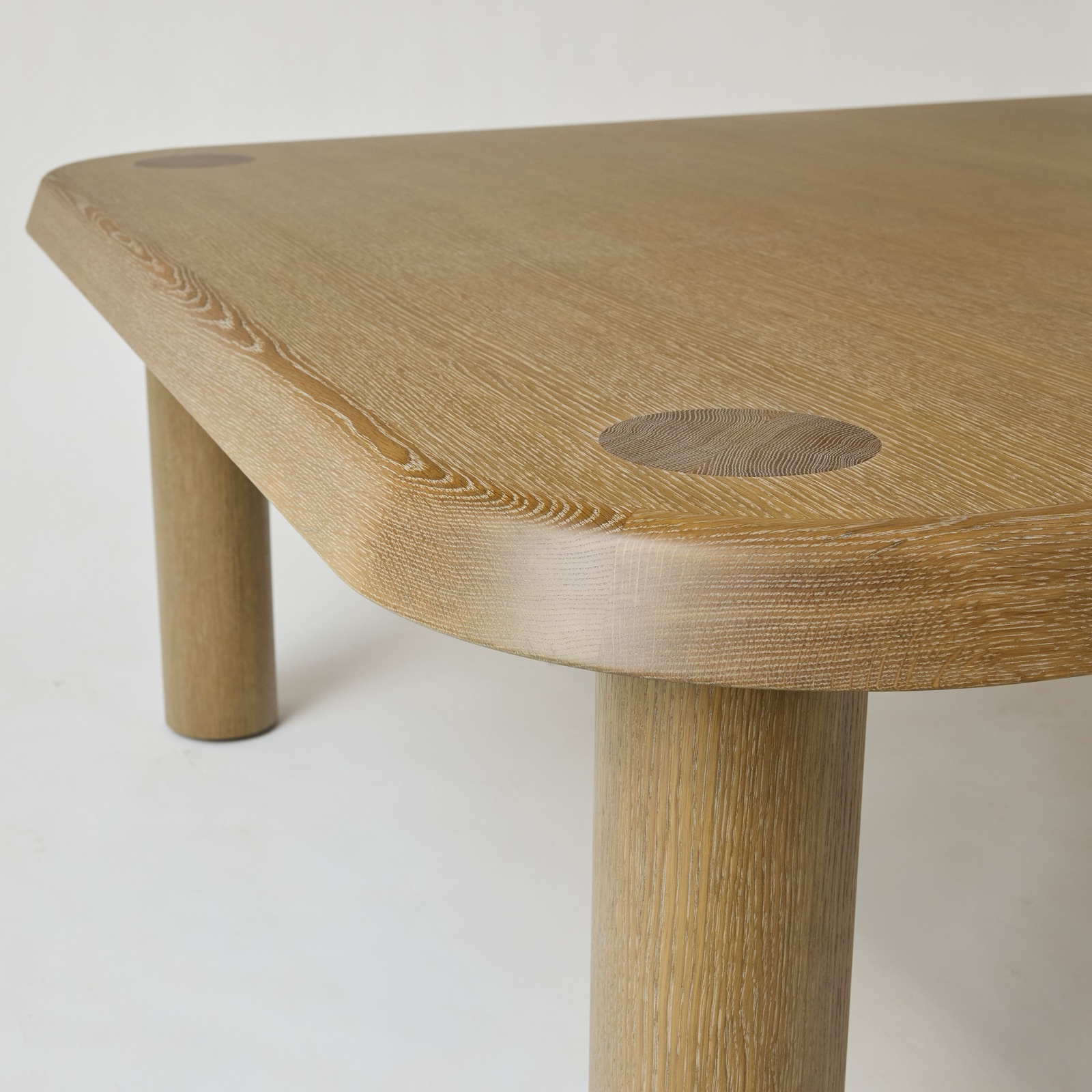 Corner of the table showing the shaped edge and an end grain inlay